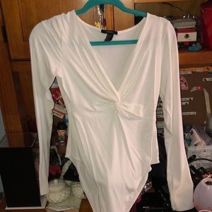A white bodysuit, low cut.